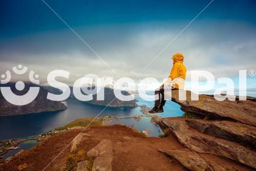 Tourist Enjoying Scenic View In Lofoten, Norway